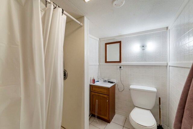 16040 Lockwood Ave, Oak Forest, IL 60452 - full bath with a shower with shower curtain, tile patterned flooring, toilet, vanity, and tile walls