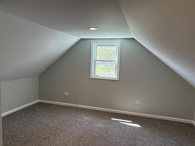 bonus room with vaulted ceiling, carpet, and baseboards