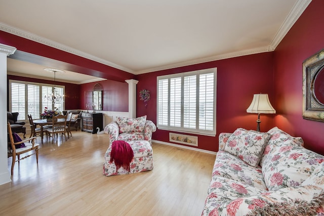 24706 Apollo Dr, Plainfield, IL 60585 - living area with decorative columns, wood finished floors, crown molding, a chandelier, and baseboards