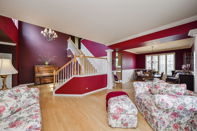 24706 Apollo Dr, Plainfield, IL 60585 - living area with a chandelier, crown molding, stairs, wood finished floors, and wainscoting