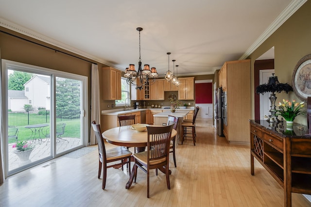 24706 Apollo Dr, Plainfield, IL 60585 - dining room with crown molding, a chandelier, and light wood-style flooring