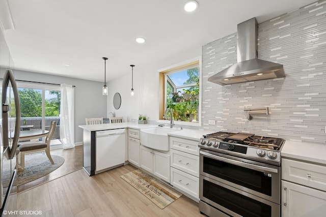 202 W Tanglewood Dr, Arlington Heights, IL 60004 - kitchen with wall chimney exhaust hood, white dishwasher, double oven range, tasteful backsplash, and light countertops