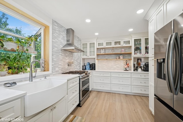 202 W Tanglewood Dr, Arlington Heights, IL 60004 - kitchen featuring appliances with stainless steel finishes, wall chimney exhaust hood, light countertops, white cabinets, and recessed lighting