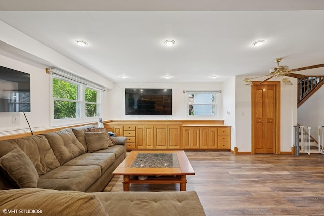 202 W Tanglewood Dr, Arlington Heights, IL 60004 - living area featuring light wood finished floors, stairway, healthy amount of natural light, and ceiling fan