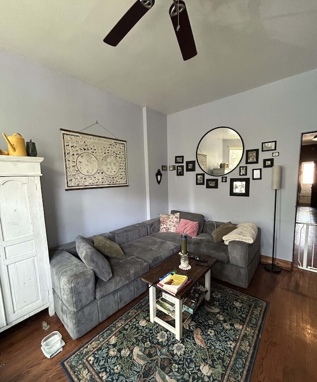 living area featuring a ceiling fan and wood finished floors