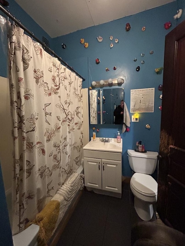full bathroom featuring toilet, shower / bath combo with shower curtain, vanity, and tile patterned flooring