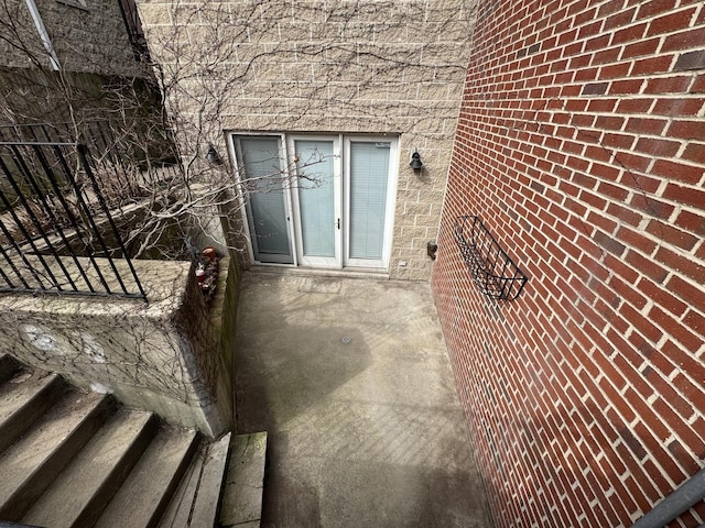entrance to property featuring stone siding
