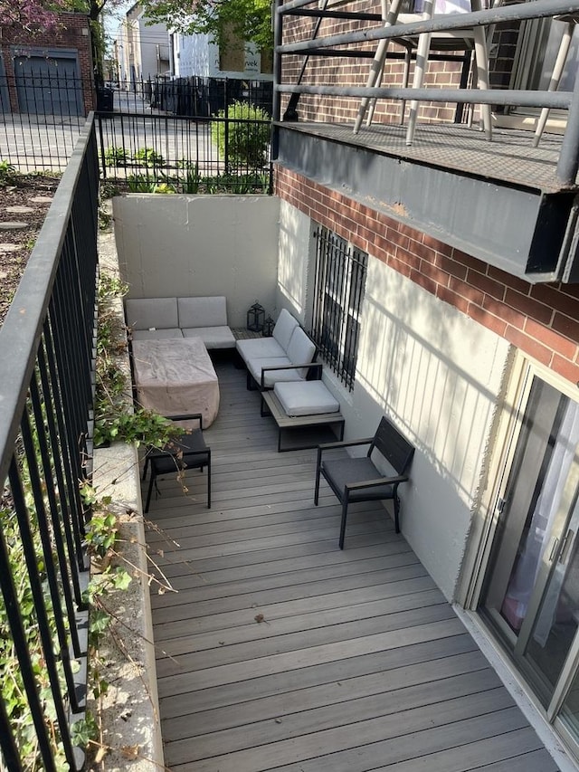 wooden deck featuring an outdoor living space and fence