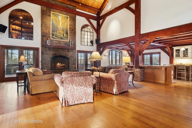 236 Steeplechase Rd, Barrington Hills, IL 60010 - living area with hardwood / wood-style floors, beamed ceiling, high vaulted ceiling, and a stone fireplace