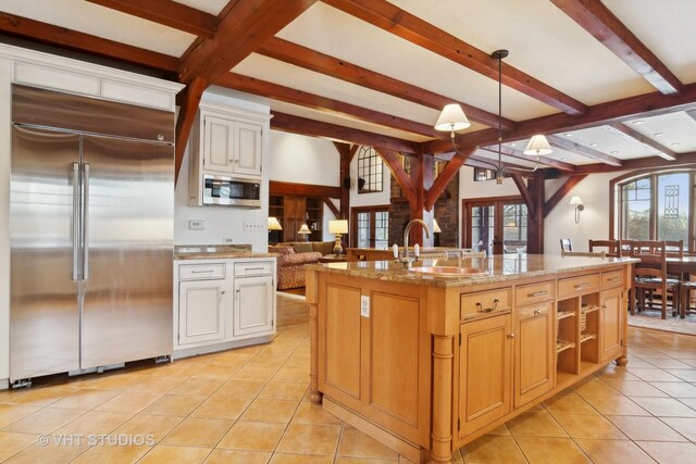 236 Steeplechase Rd, Barrington Hills, IL 60010 - kitchen with appliances with stainless steel finishes, beam ceiling, light tile patterned flooring, decorative light fixtures, and a sink