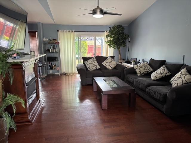 3245 Bremerton Ln, Aurora, IL 60504 - living room with a ceiling fan and dark wood-type flooring