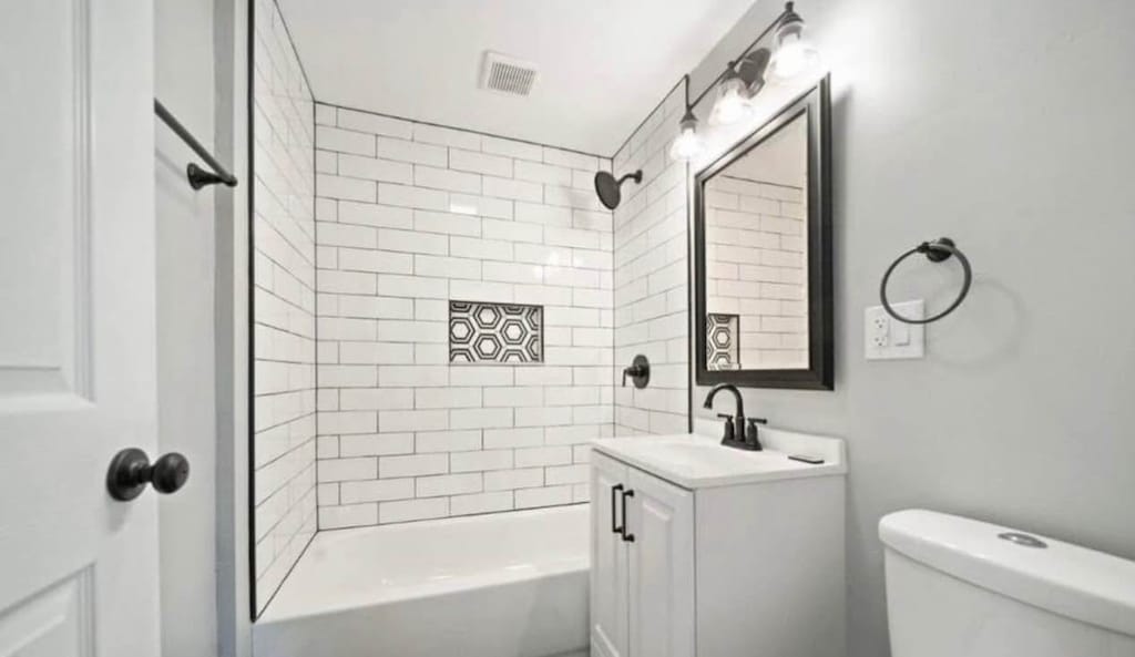 14808 Leavitt Ave, Harvey, IL 60426 - bathroom featuring toilet, shower / bathtub combination, and vanity