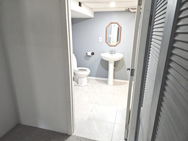 bathroom featuring toilet and tile patterned floors