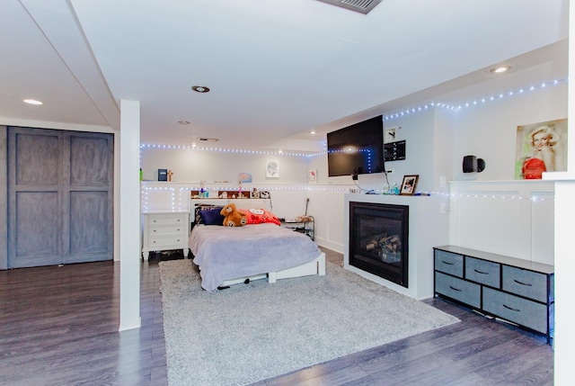 5236 N Mobile Ave, Chicago, IL 60630 - bedroom featuring wood finished floors, recessed lighting, and a glass covered fireplace