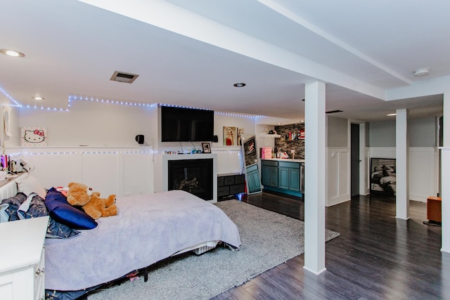 5236 N Mobile Ave, Chicago, IL 60630 - bedroom with dark wood-type flooring, bar area, a fireplace, and recessed lighting