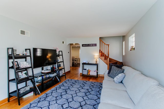 5236 N Mobile Ave, Chicago, IL 60630 - living area with arched walkways, stairs, and wood finished floors