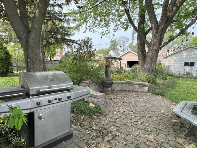 5236 N Mobile Ave, Chicago, IL 60630 - view of patio with a grill, an outdoor structure, and fence