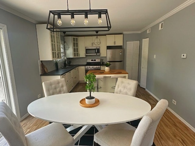 620 Teton Cir, Carol Stream, IL 60188 - dining space with crown molding, baseboards, and dark wood finished floors