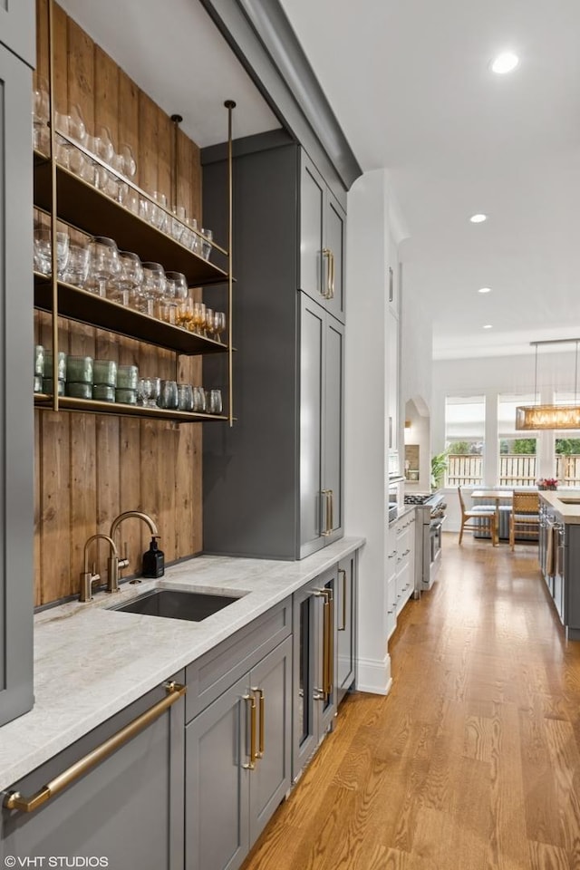 4300 Franklin Ave, Western Springs, IL 60558 - bar featuring a sink, light wood finished floors, pendant lighting, high end range, and recessed lighting
