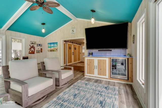 7500 US Highway 34, Oswego, IL 60543 - living room with lofted ceiling, wood finished floors, beverage cooler, wooden walls, and ceiling fan