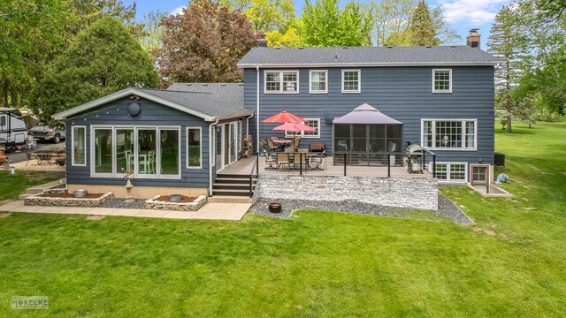 7500 US Highway 34, Oswego, IL 60543 - rear view of house featuring a chimney, a yard, a wooden deck, a patio area, and a shingled roof
