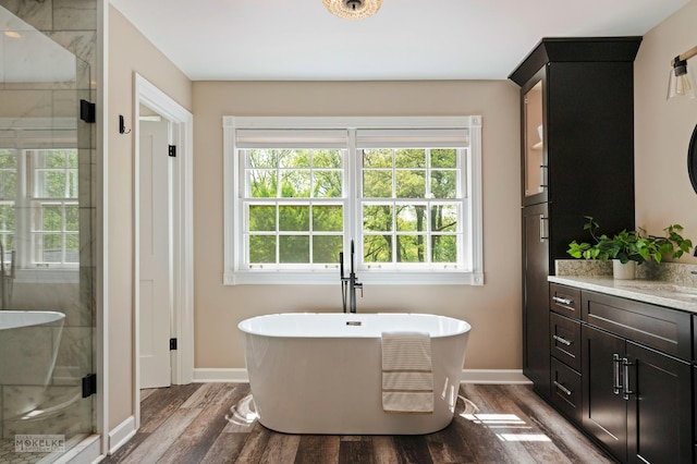 7500 US Highway 34, Oswego, IL 60543 - bathroom featuring vanity, a stall shower, baseboards, and wood finished floors