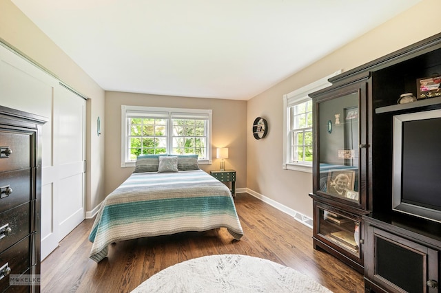 7500 US Highway 34, Oswego, IL 60543 - bedroom featuring multiple windows, baseboards, and wood finished floors