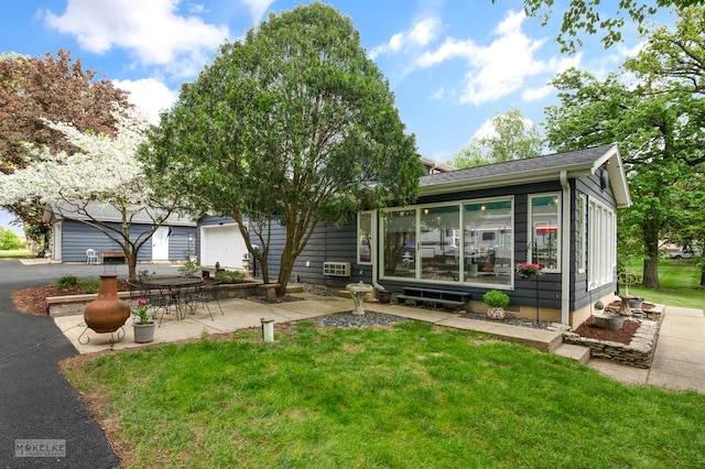 7500 US Highway 34, Oswego, IL 60543 - view of front of house with a sunroom, a front lawn, and a patio