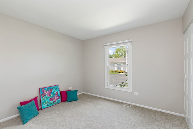 rec room featuring carpet flooring and baseboards