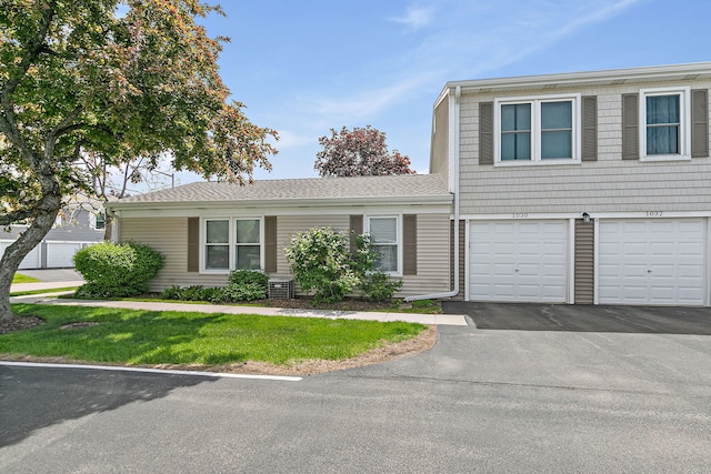 view of front of property with driveway, a garage, and a front yard