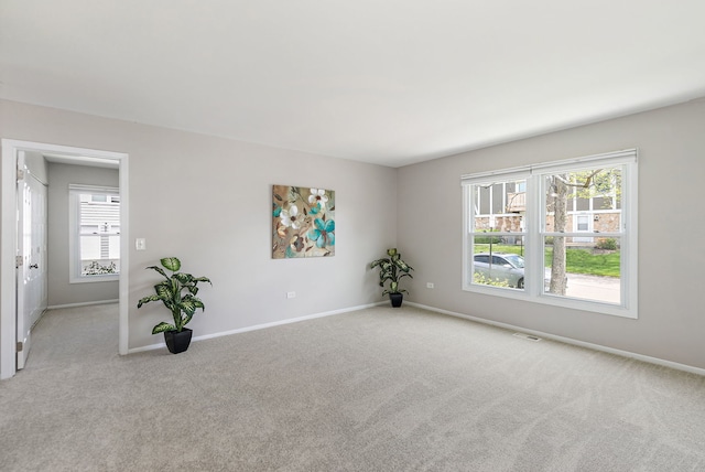 carpeted spare room with baseboards
