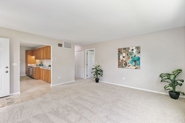 unfurnished living room with light colored carpet and baseboards
