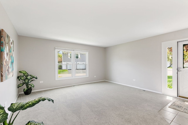 carpeted spare room featuring baseboards