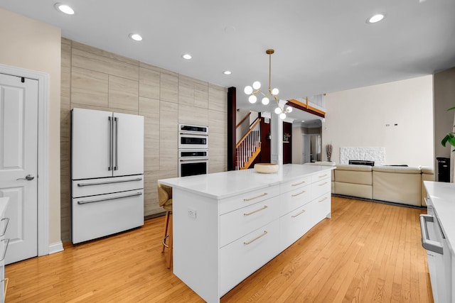 39W027 Dean St, Saint Charles, IL 60175 - kitchen featuring white appliances, modern cabinets, light wood finished floors, a center island, and open floor plan