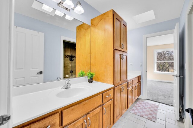 39W027 Dean St, Saint Charles, IL 60175 - bathroom featuring a skylight, vanity, and tile patterned flooring