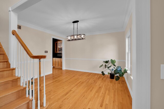 39W027 Dean St, Saint Charles, IL 60175 - entryway with crown molding, light wood-style floors, stairs, baseboards, and a chandelier