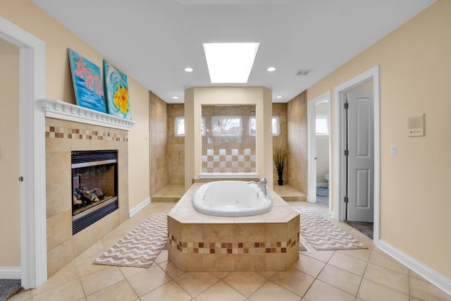 39W027 Dean St, Saint Charles, IL 60175 - bathroom featuring a jetted tub, tile patterned flooring, a fireplace, toilet, and a skylight