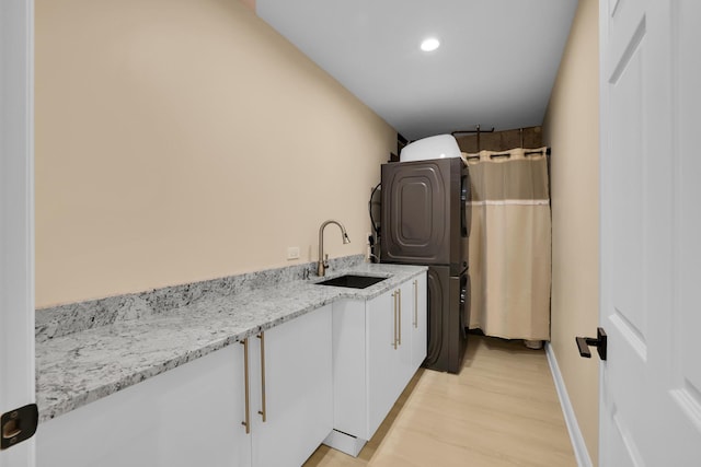 39W027 Dean St, Saint Charles, IL 60175 - clothes washing area featuring stacked washer and clothes dryer, light wood finished floors, cabinet space, recessed lighting, and baseboards