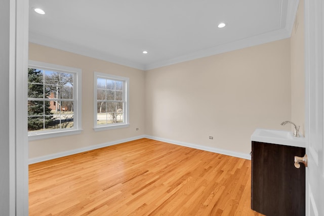 39W027 Dean St, Saint Charles, IL 60175 - empty room featuring a sink, light wood-style flooring, baseboards, ornamental molding, and recessed lighting