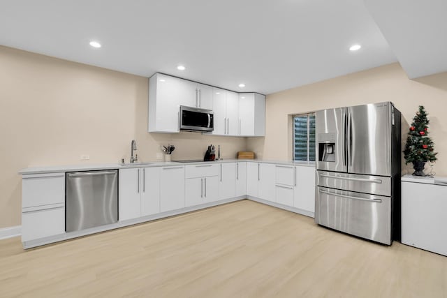 39W027 Dean St, Saint Charles, IL 60175 - kitchen featuring stainless steel appliances, a sink, white cabinetry, light wood-style floors, and recessed lighting