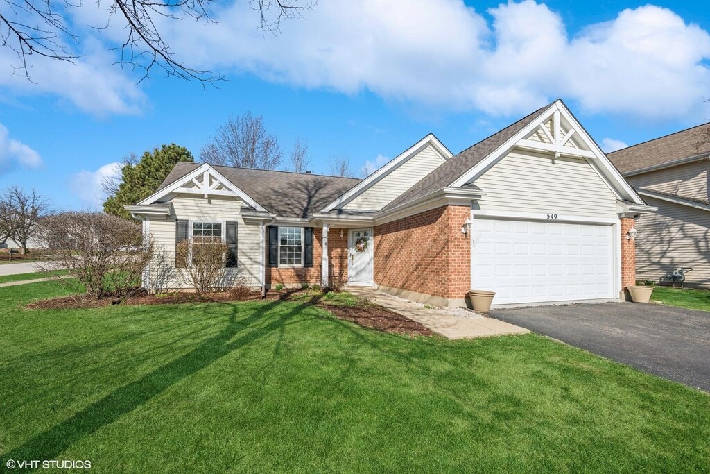 549 Ascot Ct, Lake Zurich, IL 60047 - ranch-style house featuring driveway, an attached garage, a front lawn, brick siding, and roof with shingles