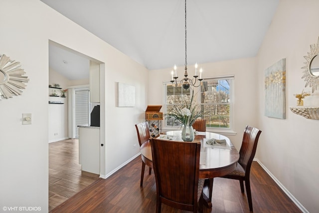 dining room with a chandelier, lofted ceiling, wood finished floors, and baseboards