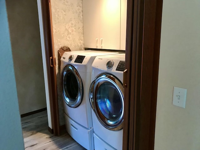 116 N Beech St, Princeton, IL 61356 - clothes washing area with separate washer and dryer, cabinet space, and light wood-style flooring