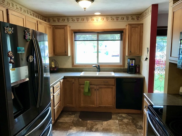 116 N Beech St, Princeton, IL 61356 - kitchen featuring black appliances, a sink, light countertops, and stone finish flooring
