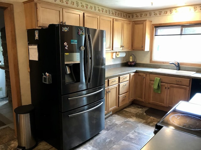 116 N Beech St, Princeton, IL 61356 - kitchen with a sink, black appliances, light countertops, dark stone finish floors, and light brown cabinets