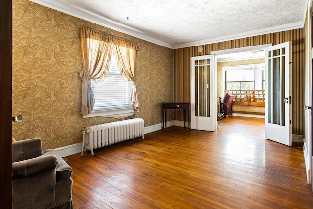 546 Elmwood Ct, El Paso, IL 61738 - unfurnished room with radiator, wallpapered walls, hardwood / wood-style flooring, plenty of natural light, and crown molding