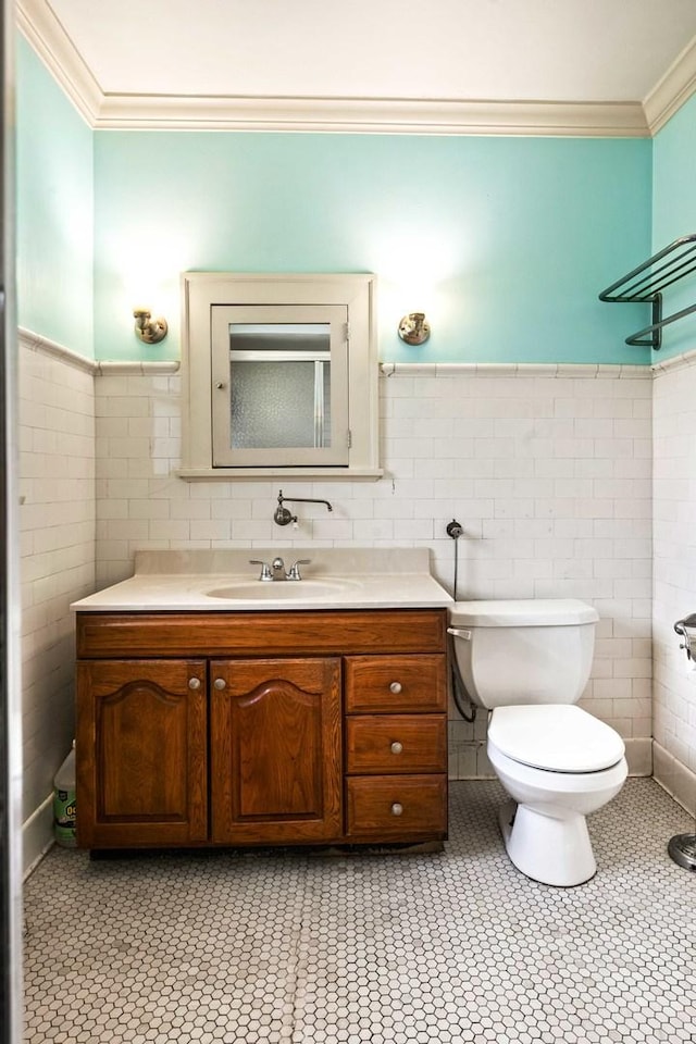 546 Elmwood Ct, El Paso, IL 61738 - full bathroom with crown molding, toilet, a wainscoted wall, tile walls, and vanity