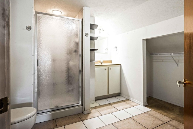 546 Elmwood Ct, El Paso, IL 61738 - bathroom featuring vanity, a textured ceiling, tile patterned floors, a shower stall, and toilet