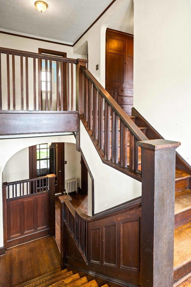 546 Elmwood Ct, El Paso, IL 61738 - staircase with wood finished floors, radiator, and ornamental molding