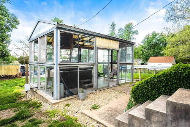546 Elmwood Ct, El Paso, IL 61738 - back of house featuring a sunroom and fence